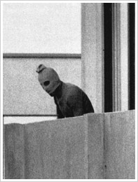 A hooded member of the Palestinian terrorist group Black September on the balcony of the Munich Olympic Village building, September 5, 1972. The group seized members of the Israeli Olympic team.