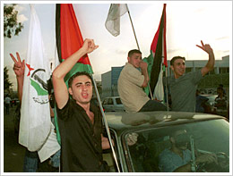 On September 11, Palestinians at the Ein el-Hilweh refugee camp near Sidon, Lebanon, celebrated the news of the attacks by flashing the victory sign and waving Palestinian flags.